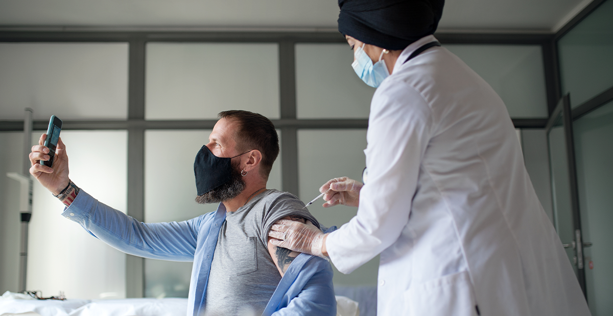 Man taking selfie during medical exam.